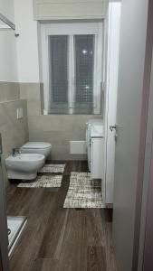 a bathroom with two toilets and a sink and a tub at Casa Vacanza Giorgio Apartment in Gallarate +14 photos