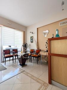 a living room with chairs and a table at Marie Claire Studios in Olympic Beach