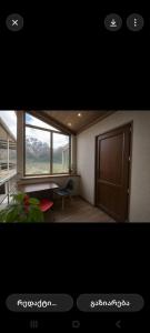 a picture of a room with a desk and a window at Tamila Guest House in Kazbegi