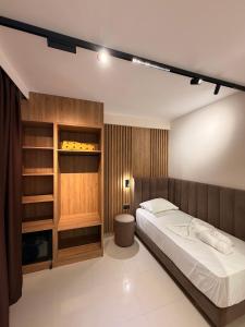 a bedroom with a bed and a closet at Vila Llaman Luxury Rooms in Himare