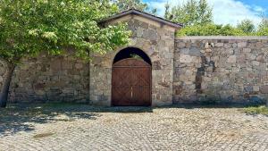 a stone wall with a wooden door on it at Cinarli Kasri in Gokceada Town +82 photos