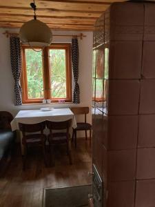 a dining room with a table and a window at Cottage by the Ponds in Krasňany