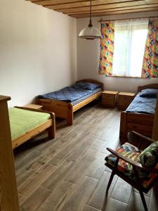 a small room with two beds and a window at Cottage by the Ponds in Krasňany