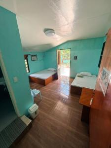 a room with two beds and a hallway at Cebu - Victoria's Guest House in Badian