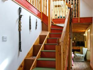 a staircase in a house with red and green carpet at The Smiddy - S4278 in Lochearnhead +9 photos