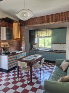 a kitchen with a table and a couch at KolymBeddra in Agrigento