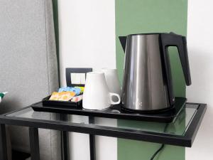 a coffee pot on a tray on a table at Milano Brenta Suites Room for 2 in Milan