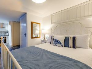 a bedroom with a large bed with a large headboard at Lake View-Uk34414 in Cheddar