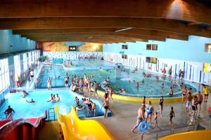 a group of people in a swimming pool at Apartamenty Amon z widokiem na morze in Darlowko