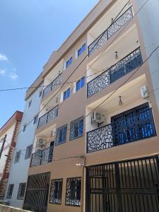 a building with a bunch of balconies on it at Modern 1bedroom apartment in Douala