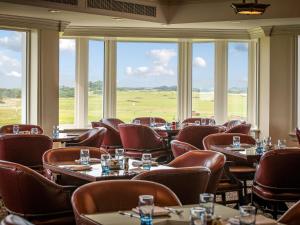 a restaurant with tables and chairs and large windows at Royal Aberdeen - Ukc6917 in Turnberry