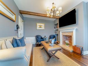 a living room with a couch and a fireplace at Royal Aberdeen - Ukc6917 in Turnberry +9 photos