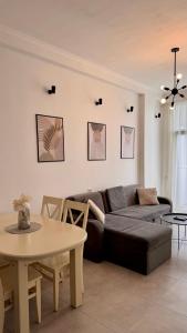 a living room with a couch and a table at Kutaisi Glow in Kutaisi