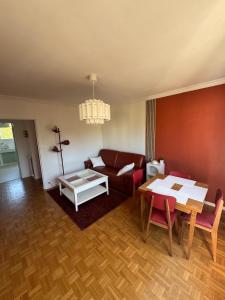 a living room with a couch and a table at Grand appartement dans une résidence à caen in Caen