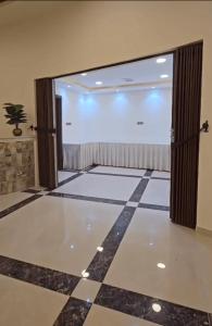 a room with a large window and a large projection screen at Ezdan Residence إزدان رزيدينس in Unayzah +4 photos