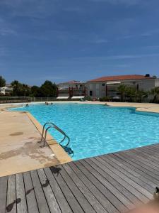 a large blue swimming pool with a wooden deck at wonderful sea view in Antibes