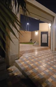 a garage with a checkered floor at night at Ezdan Residence إزدان رزيدينس in Unayzah