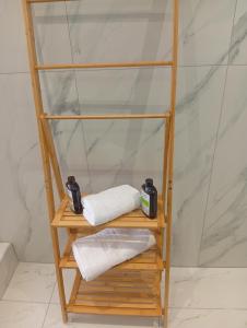 a wooden shelf with towels on it in a bathroom at private house in Sozopoli +103 photos