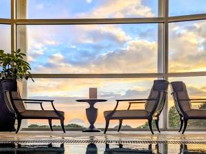 a room with two chairs and a table in front of a large window at Royal Dornoch - Ukc6918 in Turnberry