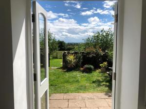 an open door with a view of a yard at Orchard View-Uk34417 in Cheddar