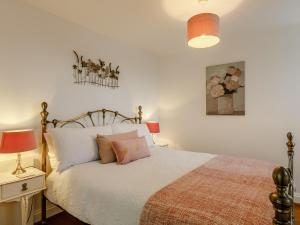 a bedroom with a large bed with two lamps on it at Orchard View-Uk34417 in Cheddar +9 photos