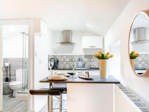 a white kitchen with a sink and a toilet at Tor View-Uk34415 in Cheddar