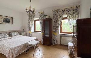 a bedroom with a large bed and two windows at Lovely Home In Tarquinia in Tarquinia +28 photos