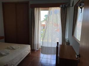 a hotel room with a bed and a window at Gerês maravilha in Geres