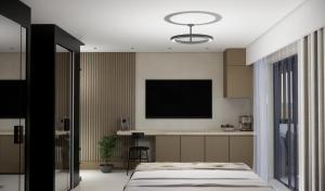 a bedroom with a bed and a flat screen tv at Nerion Hotel & Spa in Agia Marina Nea Kydonias