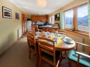 a kitchen and dining room with a table and chairs at Nether Carness in North Ballachulish