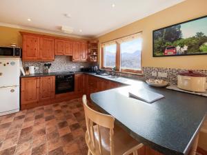 a kitchen with a large island with a counter top at Nether Carness in North Ballachulish +17 photos