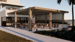 a restaurant with tables and chairs under a pavilion at Nerion Hotel & Spa in Agia Marina Nea Kydonias