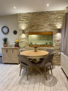 a dining room with a wooden table and chairs at Tsoukanas Studios in Patitiri