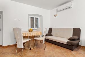 a living room with a table and a couch at Apartment old Town in Lovran