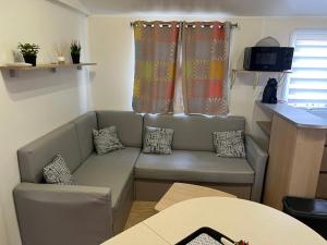 a living room with a couch and a table at Mobilehome in Vias