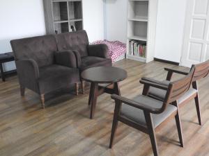 a living room with a couch and a table and chairs at Homestay House - Tamparuli in Tamparuli