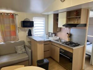 a small kitchen with a sink and a stove at Mobilehome in Vias
