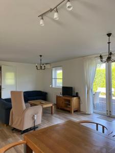 a living room with a couch and a table at B&K het hoenveld in Driel