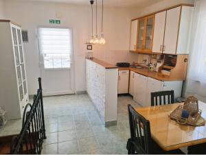 a kitchen with a table and a dining room at Vecky in Jezera