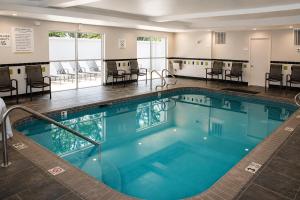 a large swimming pool with chairs and tables at City Express by Marriott Lafayette in Lafayette +9 photos