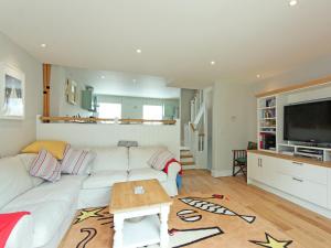 a living room with a white couch and a table at Eddystone Row 2 in Salcombe