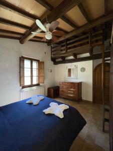 a bedroom with a blue bed with two towels on it at Eclissi casa vacanza LUNA in Casalini +7 photos
