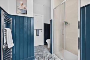 a bathroom with a blue door and a toilet at Castleview in Hillsborough +38 photos