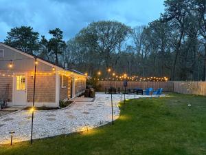a backyard lit up at night with string lights at Prime Weeks Still Available, Renovated, Beaches! in Yarmouth