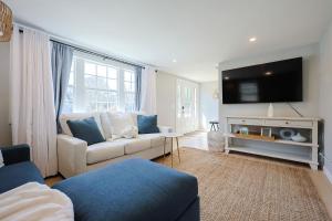 a living room with a couch and a tv at Prime Weeks Still Available, Renovated, Beaches! in Yarmouth