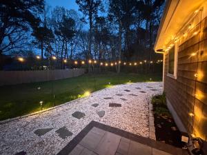 a patio with lights on the side of a house at Prime Weeks Still Available, Renovated, Beaches! in Yarmouth +28 photos