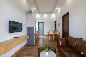a living room with a couch and a refrigerator at Golden Hill Villas Phu Quoc in Phú Quốc