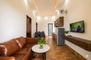 a living room with a couch and a table at Golden Hill Villas Phu Quoc in Phú Quốc