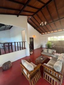 a living room with a couch and chairs and a table at The Red Loft Mihinthale in Anuradhapura