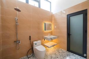a bathroom with a toilet and a sink at Golden Hill Villas Phu Quoc in Phú Quốc +33 photos